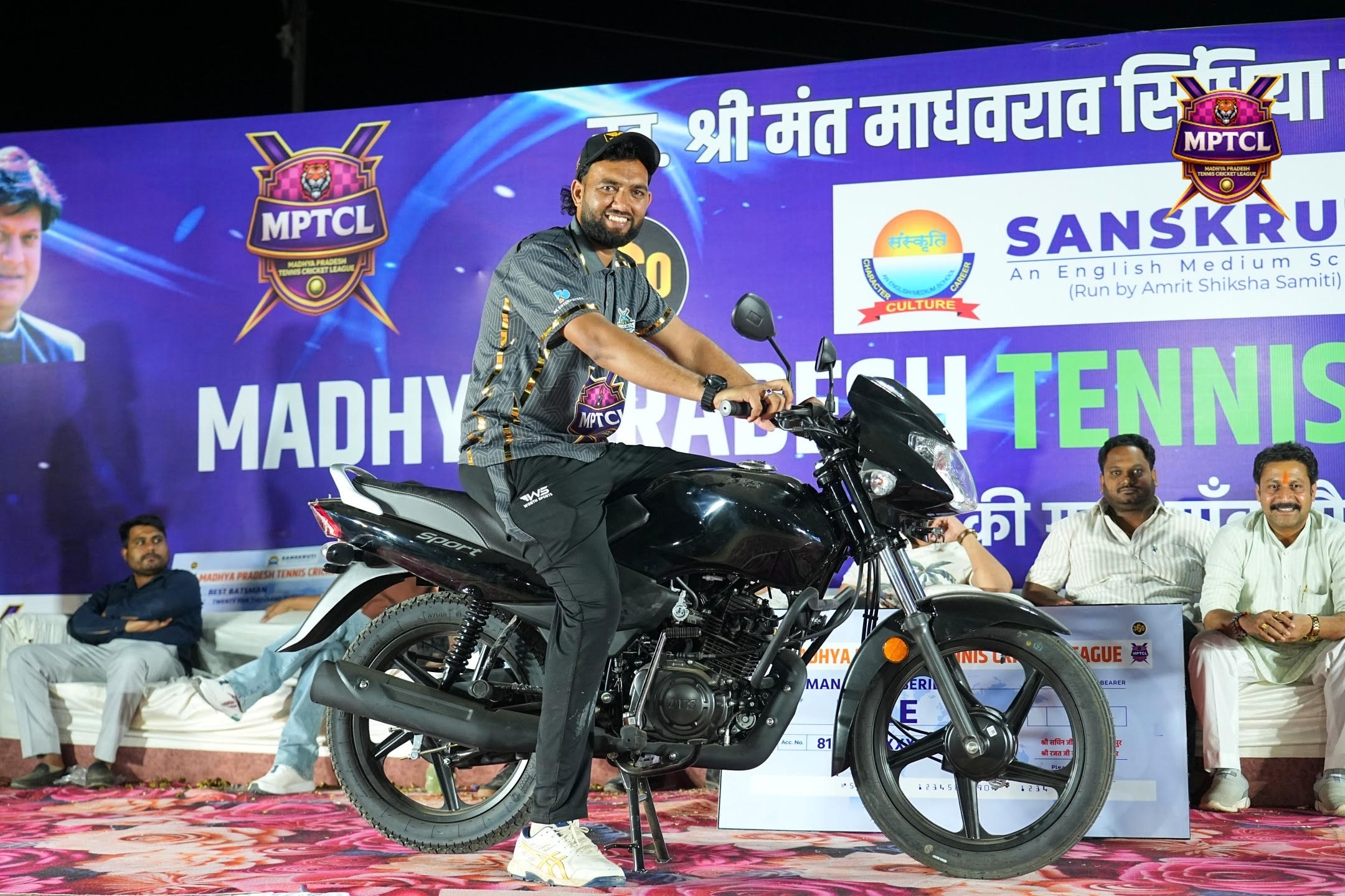 Motorbike prize reveal on stage at MPTCL 2025